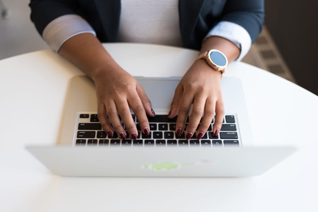 Content writer typing on laptop