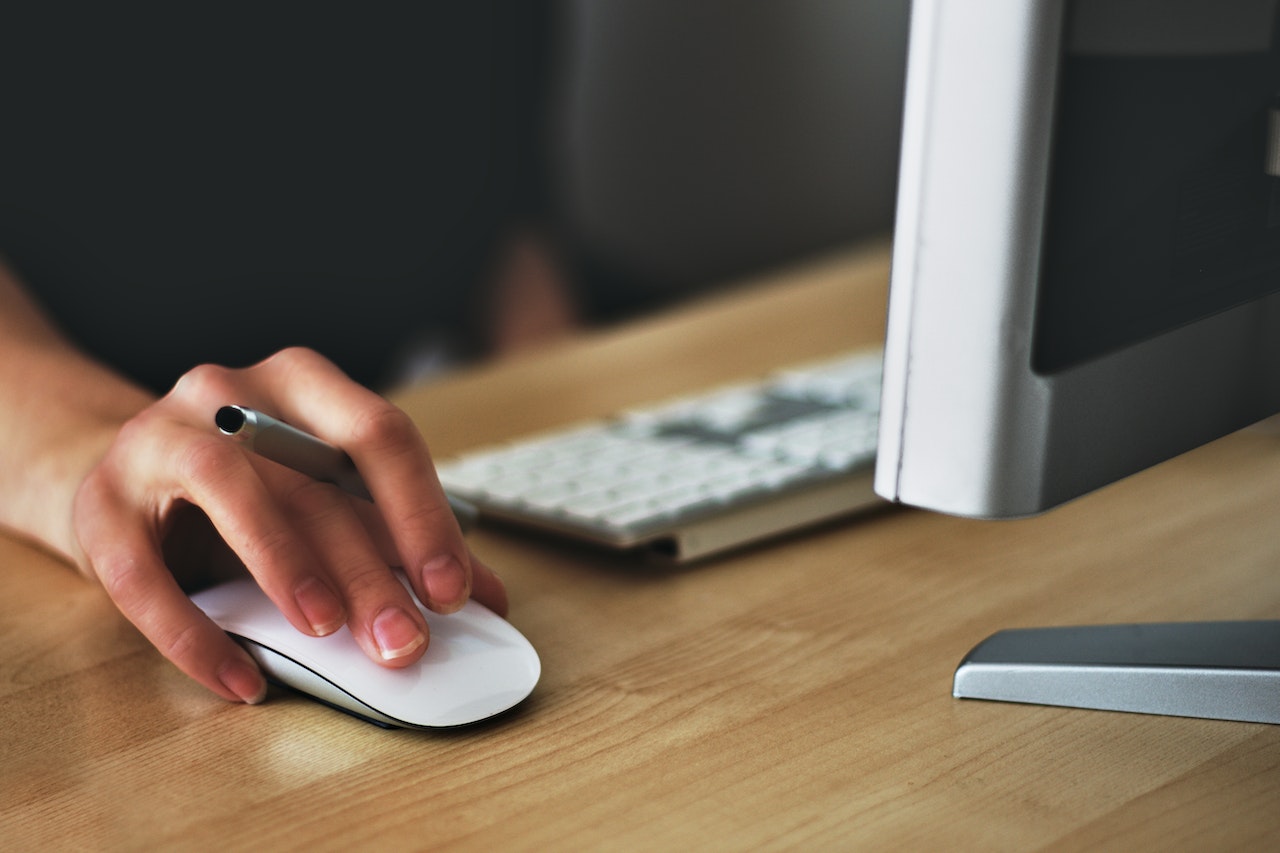 person using computer and mouse